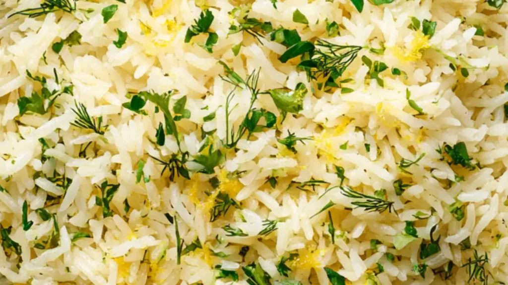 Lemon rice with dill and parsley in a shallow bowl