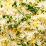 Lemon rice with dill and parsley in a shallow bowl