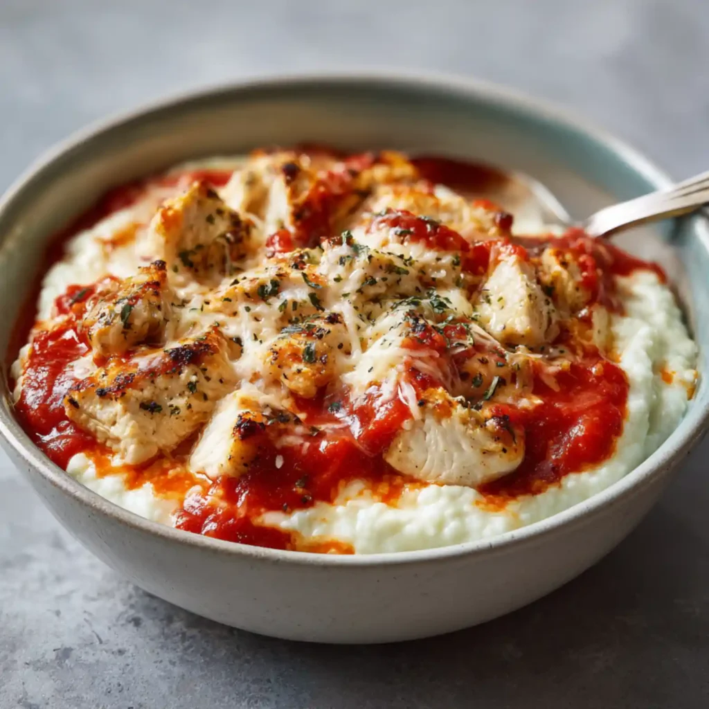 Low carb chicken parmesan bowl with cottage cheese and melted cheese topping