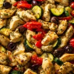 Low carb Mediterranean chicken cooked with zucchini, tomatoes, olives, and herbs