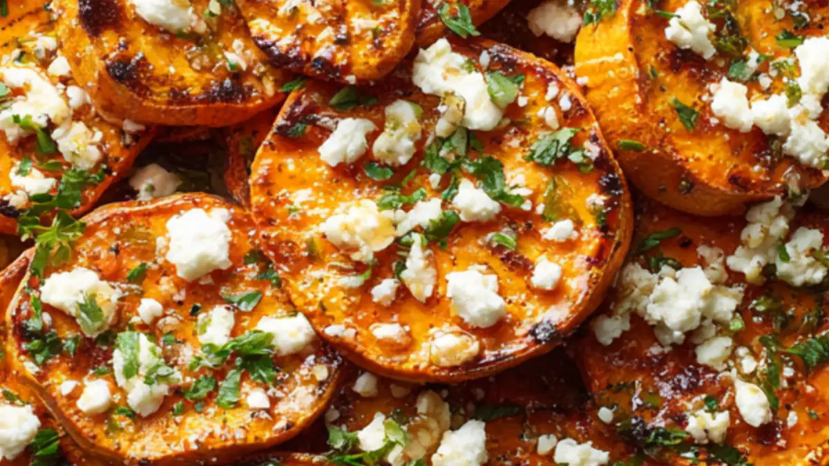 Roasted sweet potato rounds topped with crumbled feta and fresh herbs