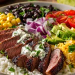 Steak burrito bowl with sliced grilled steak, rice, black beans, corn, avocado and cherry tomatoes