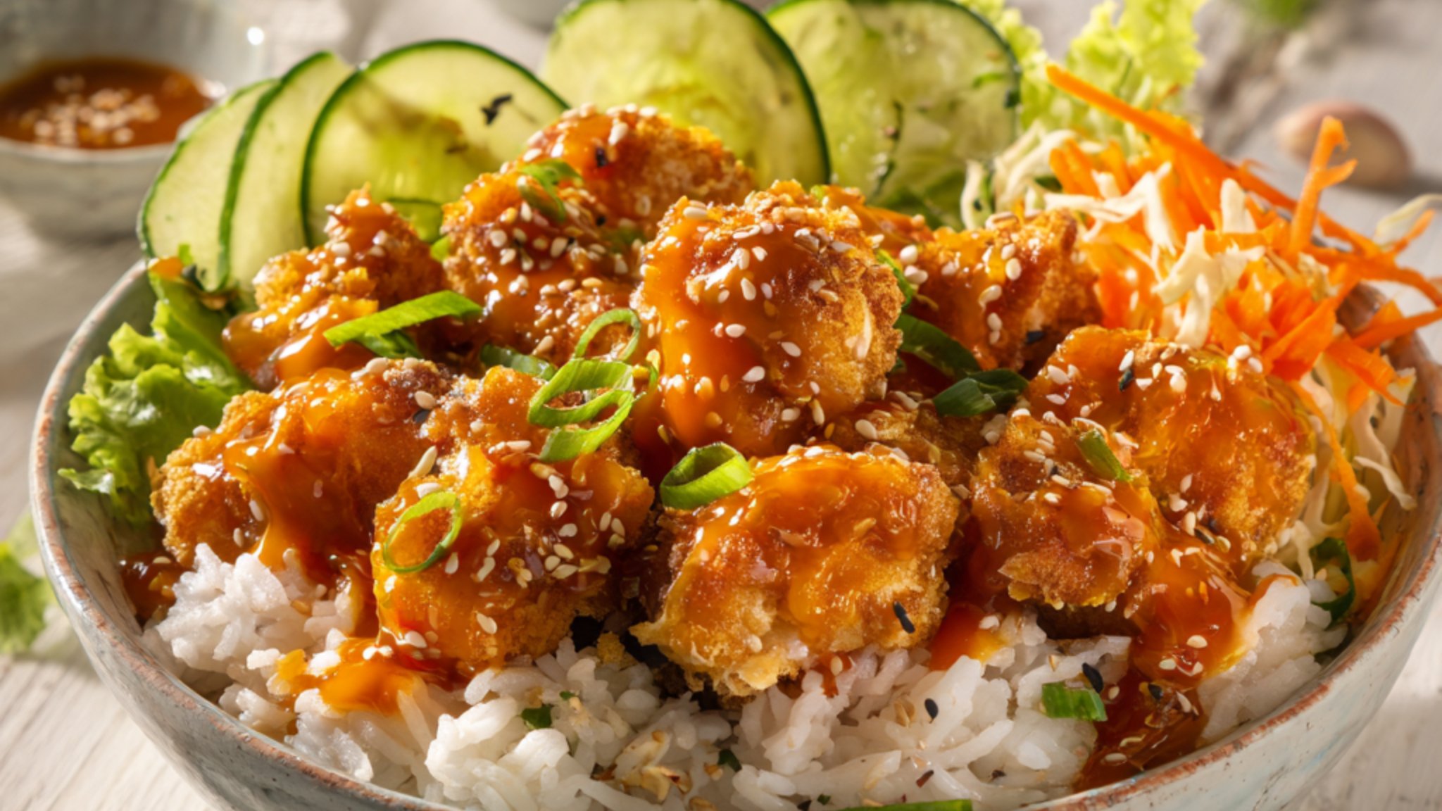 bang bang chicken bowl with crispy chicken rice and vegetables