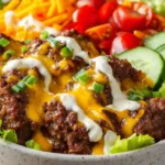 smash burger bowl with beef, cheese, lettuce, tomatoes and cucumbers