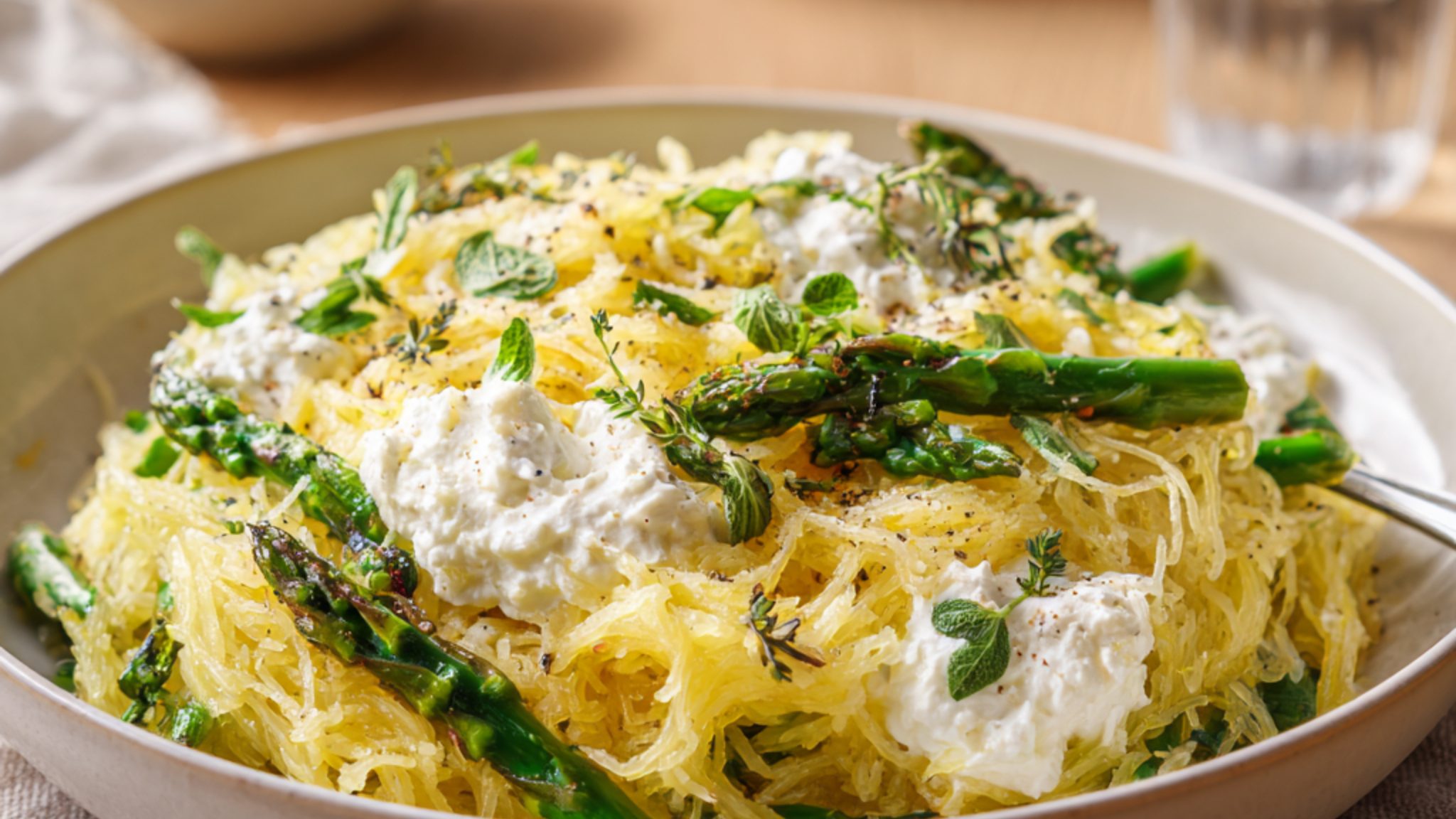 spaghetti squash with asparagus ricotta and fresh herbs in bowl