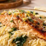 Pan seared salmon served with creamy lemon orzo and spinach